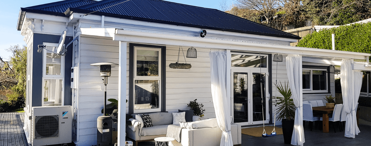 Front of white house with beautiful outdoor furnishing